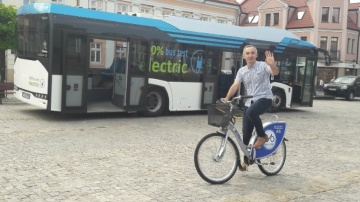 Autobus elektryczny i wypożyczalnia rowerów miejskich na placu